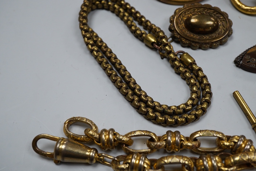 A group of gilt metal/pinchbeck jewels, 19th and early 20th century, comprising: a brooch of knotted design; two gate bracelets; a fancy link bracelet; an open-faced pocket watch; two oval panel brooches, and two watch c